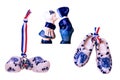 Traditional dutch porcelain shoes with a ribbon flag and kissing boy and a girl in traditional Dutch costumes isolated. Holland Royalty Free Stock Photo