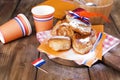 Traditional Dutch sweet pastries. Feast day of the King. Decor. Orange things for the holiday. Netherlands. Donuts and utensils