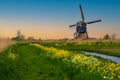 Traditional Dutch Windmill by the canal Broekmolen, Molenlanden Nieuwpoort, Netherlandsby  Holland, rural landscape at sunset Royalty Free Stock Photo