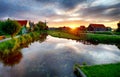 Traditional dutch windmill near the canal. Netherlands, Landcape at sunset Royalty Free Stock Photo