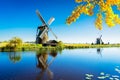 Dutch windmill over river waters Royalty Free Stock Photo