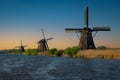 Traditional Dutch Windmills by the canal Kinderdijk village, Netherlands  Holland, rural landscape at sunset Royalty Free Stock Photo
