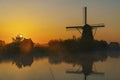 Traditional Dutch windmills with a colourful sky just before sunrise in Kinderdijk, The Netherlands Royalty Free Stock Photo