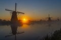 Traditional Dutch windmills with a colourful sky just before sunrise in Kinderdijk, The Netherlands Royalty Free Stock Photo