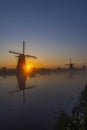 Traditional Dutch windmills with a colourful sky just before sunrise in Kinderdijk, The Netherlands Royalty Free Stock Photo