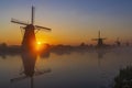 Traditional Dutch windmills with a colourful sky just before sunrise in Kinderdijk, The Netherlands Royalty Free Stock Photo