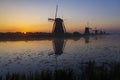 Traditional Dutch windmills with a colourful sky just before sunrise in Kinderdijk, The Netherlands Royalty Free Stock Photo