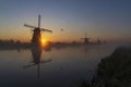 Traditional Dutch windmills with a colourful sky just before sunrise in Kinderdijk, The Netherlands Royalty Free Stock Photo