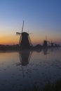 Traditional Dutch windmills with a colourful sky just before sunrise in Kinderdijk, The Netherlands Royalty Free Stock Photo