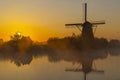 Traditional Dutch windmills with a colourful sky just before sunrise in Kinderdijk, The Netherlands Royalty Free Stock Photo