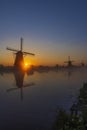 Traditional Dutch windmills with a colourful sky just before sunrise in Kinderdijk, The Netherlands Royalty Free Stock Photo