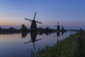 Traditional Dutch windmills with a colourful sky just before sunrise in Kinderdijk, The Netherlands Royalty Free Stock Photo