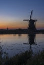 Traditional Dutch windmills with a colourful sky just before sunrise in Kinderdijk, The Netherlands Royalty Free Stock Photo