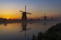 Traditional Dutch windmills with a colourful sky just before sunrise in Kinderdijk, The Netherlands Royalty Free Stock Photo