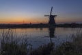 Traditional Dutch windmills with a colourful sky just before sunrise in Kinderdijk, The Netherlands Royalty Free Stock Photo