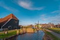 Traditional Dutch windmills in the rural landscape of Zaanse Schans village. Ancient houses brightly colored Royalty Free Stock Photo