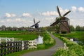 Traditional Dutch windmills and winding road in a countryside of Kinderdijk, Netherlands, Holland, rural landscape, lifestyle Royalty Free Stock Photo