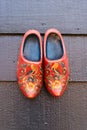 Traditional dutch wooden shoes hanging at a wall