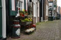 Traditional dutch wooden shoes - klompen clogs, can and flower pots outside, Volendam, Netherlands Royalty Free Stock Photo