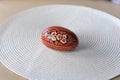 A traditional dyed colourful Easter egg in a basket with feathers in Poland called pisanka or kroszonka Royalty Free Stock Photo