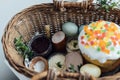 Traditional Easter basket. Natural dyed easter eggs, easter bread, ham, beets, butter, cheese in wicker basket decorated with Royalty Free Stock Photo