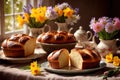 Traditional easter bread on table with flowers, traditional springtime festive holiday celebration decoration