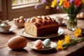 Traditional easter bread on table with flowers, traditional springtime festive holiday celebration decoration