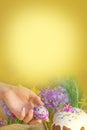 Easter egg in a hand on a background of Easter decoration and spring flowers. Easter breakfast concept. Royalty Free Stock Photo
