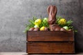 Traditional Easter chocolate bunny and eggs inside a wooden crate