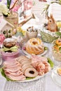 Traditional Easter dishes with platter of cured meat on festive table Royalty Free Stock Photo