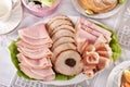 Traditional Easter dishes with platter of cured meat on festive table Royalty Free Stock Photo