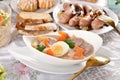 Traditional Easter dishes with white borscht and sausage on festive table Royalty Free Stock Photo