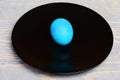 Traditional easter eggs painted in blue color on black plate Royalty Free Stock Photo