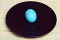 Traditional easter eggs painted in blue color on black plate Royalty Free Stock Photo