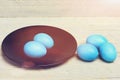 Traditional easter eggs painted in blue color on black plate Royalty Free Stock Photo