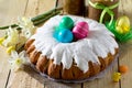 Traditional Easter food cake: the dough wrapped in a roll with nut filling and raisins, with sweet icing. Festive Easter table Royalty Free Stock Photo