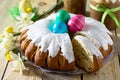 Traditional Easter food cake: the dough wrapped in a roll with nut filling and raisins, with sweet icing. Festive Easter table Royalty Free Stock Photo