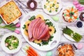Traditional Easter ham dinner. Top view table scene on a white wood background. Royalty Free Stock Photo
