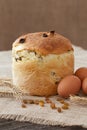 Traditional easter holiday cake sweet bread also called kulich with raisins and eggs on vintage textile Royalty Free Stock Photo