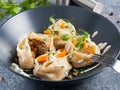 Traditional Eastern dish manti or manty with beef in a dark plate Royalty Free Stock Photo