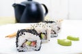 Traditional eastern dish with salmon, shrimp - sushi rolls on a white plate Royalty Free Stock Photo