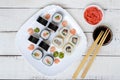 Traditional eastern dish - sushi rolls with salmon and shrimp on a white plate Royalty Free Stock Photo