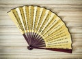 Traditional eastern fan on the wooden background Royalty Free Stock Photo