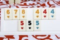 Traditional Eastern Turkish game okey with white knuckles and multicolored numbers Royalty Free Stock Photo