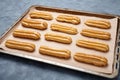 Traditional eclairs or profiterole dessert filled with whipped cream