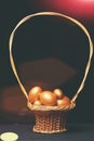 Traditional eggs painted in golden color inside pottle or basket