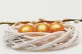 Traditional eggs painted in golden color inside woven wooden wreath Royalty Free Stock Photo