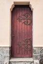 Traditional element from historic house in Europe. An old wooden door in stone wall Royalty Free Stock Photo