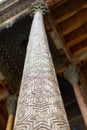 Traditional Elm carving wooden ornamented columns with kokands and ceiling. The wooden pillars support the roof of the