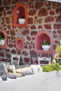 Traditional and Empty Home Restaurant with Chairs and Dining Tables in Oia or Ia Village at Santorini Island in Greece Against